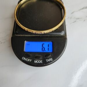 10k Gold Bangle Bracelet With Elegant Etched Design.